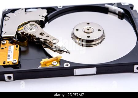 Internal parts of a hard disk isolated on a white background. Close up of Hard disk drive inside view. Stock Photo