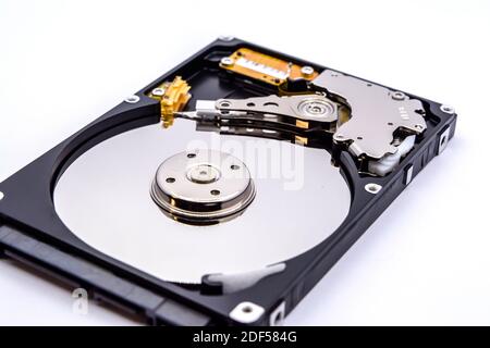 Internal parts of a hard disk isolated on a white background. Close up of Hard disk drive inside view. Stock Photo