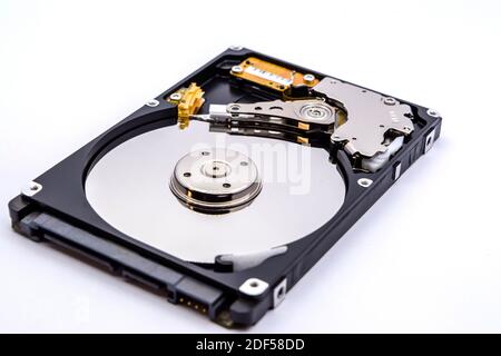 Internal parts of a hard disk isolated on a white background. Close up of Hard disk drive inside view. Stock Photo