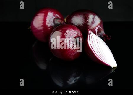 Red onions isolated on black background Stock Photo