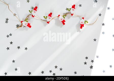 Christmas decorations Santa Claus clothespins on the white background. Christmas frame Stock Photo
