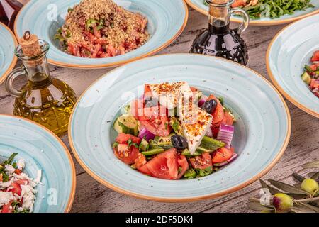 Variety of fresh vegetable salads lay flat. Collage of healthy salads. Includes chicken caesar, spinach, garden, nicoise, greek and beetroot and walnu Stock Photo