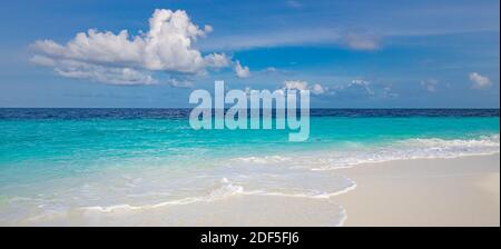 Closeup of sand on beach and blue summer sky. Panoramic beach landscape. Empty tropical beach seascape. Relaxing summer vibes, positive mood inspire Stock Photo