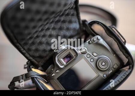 Top view of work space photographer with digital camera in camera bag, flash, battery charger, cleaning kit, tripod, memory card, and camera accessory Stock Photo