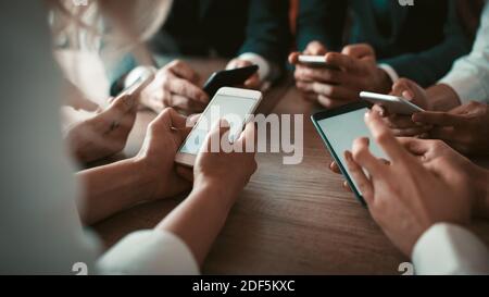 Team of app developers testing the bugs of the new app while testing usability with different operation system gadgets. Business partners are planning Stock Photo