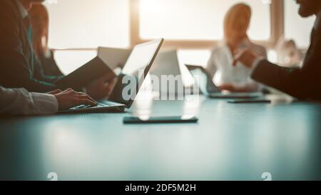 Link build developers testing usability of a new program or website with different operation system laptops in the modern office. Business partners Stock Photo