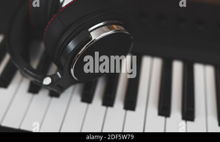 Headphones on the piano keyboard. Recording studio concept. Stock Photo