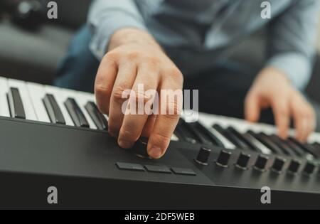 Man playing the piano in studio, recording new song. Stock Photo