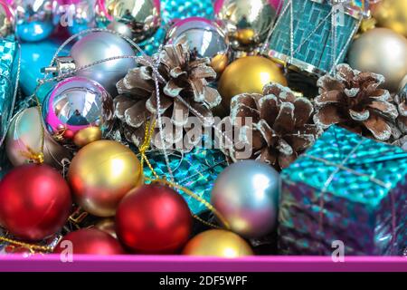 Christmas tree toys in the form of gold and silver balls, cones and close-up gift boxes. New Year's festive background Stock Photo