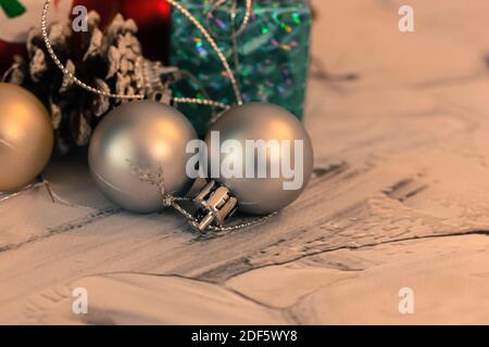 Christmas tree toys in the form of gold and silver balls, pine cones and close-up gift boxes. New Year's festive background Stock Photo