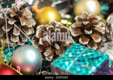 Christmas tree toys in the form of gold and silver balls, cones and close-up gift boxes. New Year's festive background Stock Photo