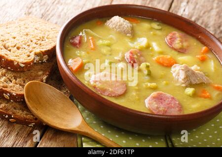 Classic Dutch pea soup erwtensoep, snert closeup in the plate on the table. horizontal Stock Photo