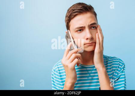 the guy is talking on the phone, upset by what he heard Stock Photo