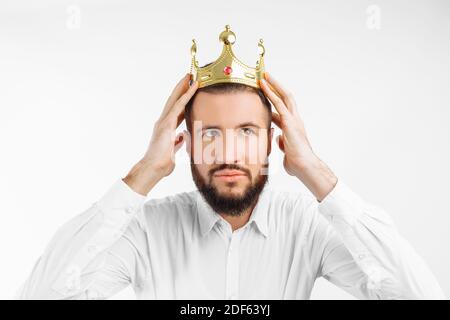 A man on a white background, wears a crown on his head Stock Photo