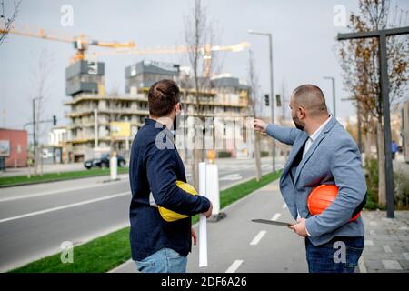 Two architects having work meeting at construction site Stock Photo