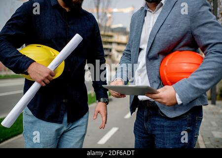 Two architects having work meeting at construction site Stock Photo