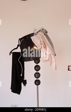 Clothes on the lamp, wardrobe mess Stock Photo