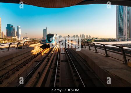 View of the train and the Dubai downtown skyline from a metro station, Dubai, UAE Stock Photo