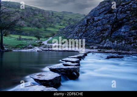 Dovedale Valley Stepping Stones on a cloudy morning in November 2020 taken with a long exposure Stock Photo