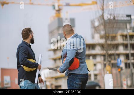 Two architects having work meeting at construction site Stock Photo