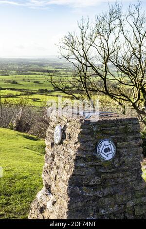 The topograph with Cotswold Way waymarks on the Cotswold viewpoint of Haresfield Beacon with the Severn Vale in the background, Gloucestershire UK