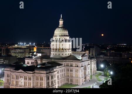 October 1, 2020 Austin, Texas:  A harvest full moon rises over the Texas Capitol in Austin, looking east from the Westgate Building. © Bob Daemmrich Stock Photo