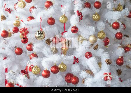 White or silver Christmas tree with red, gold toys, New Year composition Stock Photo