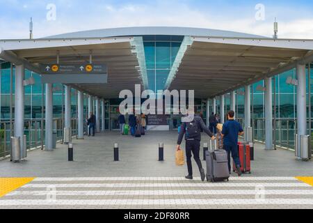 LARNACA, CYPRUS - FEB 21, 2019: People at the entrance of Larnaca International Airport – Glafcos Clerides Stock Photo