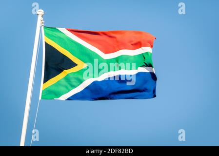 South african flag on a blue sky - Pride of the nation South Africa adopted on 27 April 1994 representing the new democracy Stock Photo