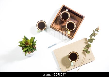 Mango wood wooden tray with four espresso coffee cups on the white background. Empty space Stock Photo