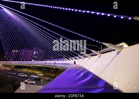 The Chords Bridge also called the Bridge of Strings or Jerusalem Light Rail Bridge designed by Santiago Calatrava lit up in purple to raise awareness about people with disabilities, positioned at the main entrance to Jerusalem in Israel. December 3 marks the International Day of Disabled Persons. Stock Photo