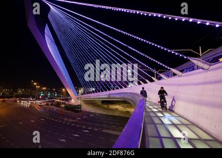 The Chords Bridge also called the Bridge of Strings or Jerusalem Light Rail Bridge designed by Santiago Calatrava lit up in purple to raise awareness about people with disabilities, positioned at the main entrance to Jerusalem in Israel. December 3 marks the International Day of Disabled Persons. Stock Photo