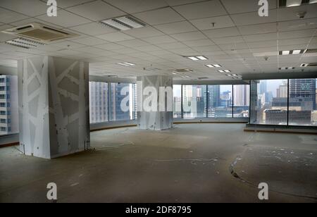 Empty, huge open-space office room with panoramic view at modern city in China. During remodeling improvement work. Stock Photo