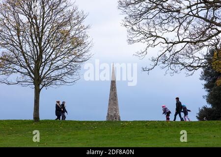 People walking in Brockwell Park with the steeple of the Holy Trinity Church in background, London Stock Photo