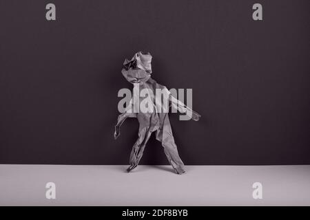 Figure of a man made from crumpled paper. Concept of confusion and loneliness. Stock Photo