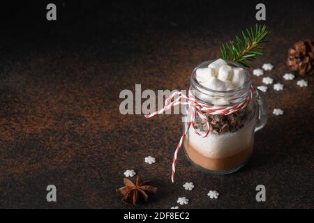 Edible Christmas gift in mason jar gift for cooking hot chocolate on brown. Close up. Stock Photo