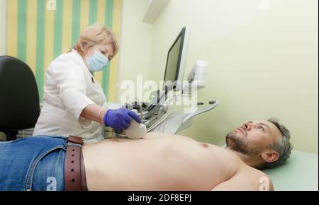 a female doctor examines a patient on an ultrasound machine Stock Photo