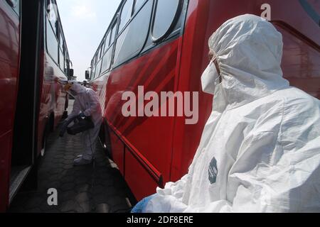 MEXICO CITY, MEXICO - DECEMBER 1: A person wears personal protective equipment suit to spray disinfectant solution on a bus station as safety measure amid the New Covid-19 pandemic as Mexico reaches 1,113,543 cases for Covid-19 on December 1, 2020 in Mexico City, Mexico. Credit: Ricardo Castelan Cruz/Eyepix Group/The Photo Access Stock Photo