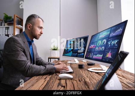 Financial Analyst Or Advisor Using KPI Data Technology On Desktop Stock Photo