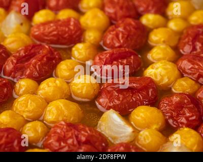 Roasted cherry tomatoes and physalis in a baking dish