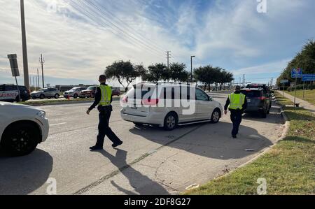 Allen, TX USA - November 27, 2020: Roadside view of police officers guiding the cars on Black Friday Stock Photo