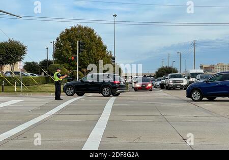 Allen, TX USA - November 27, 2020: Roadside view of police officers guiding the cars of Black Friday traffic Stock Photo