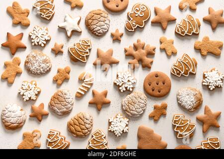 Pattern of different Christmas homemade gingerbread cookies as snowflakes, stars, christmas tree on white background. Xmas abstract background. Stock Photo