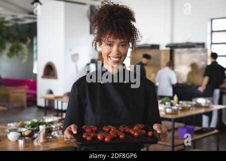 Female chef and divserse group in kitchen Stock Photo