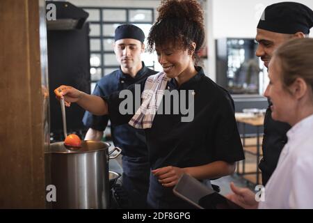 Female chef and divserse group in kitchen Stock Photo