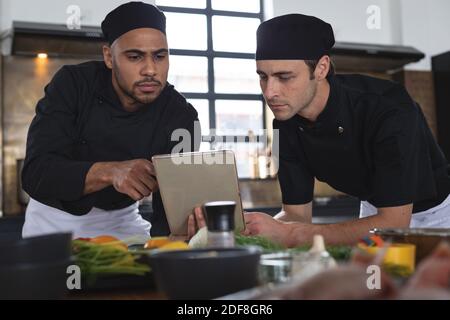 Two divserse male chefs in kitchen Stock Photo
