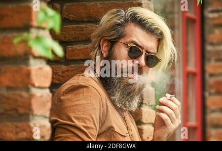 cool guy with cigarette Confident Casual Man Smoking Addiction Stock Photo 735169588 Smoking outdoors. Smoking habit. Fashionable