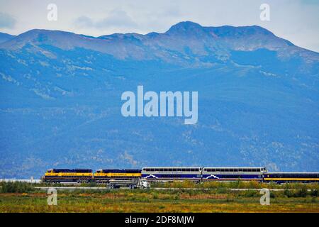 The Alaskan Railways McKinley Explorer tourist train follows the coastal track along Turnagain Arm outside Anchorage, Alaska. Stock Photo