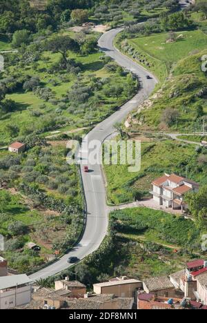 aerial view of cars are going through a winding rural road Stock Photo