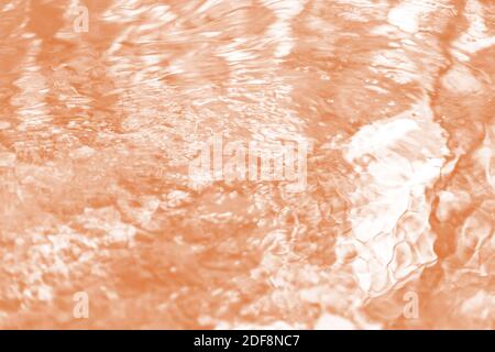 Blurred water river abstract background with waves at surface toned Tawny Birch Stock Photo